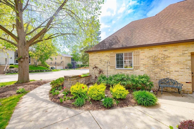 14 Golf Course Rd, Madison, WI 53704 - view of side of property featuring a shingled roof and brick siding