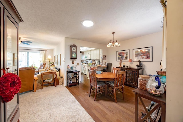 14 Golf Course Rd, Madison, WI 53704 - dining space featuring a chandelier, light wood-type flooring, and a textured ceiling