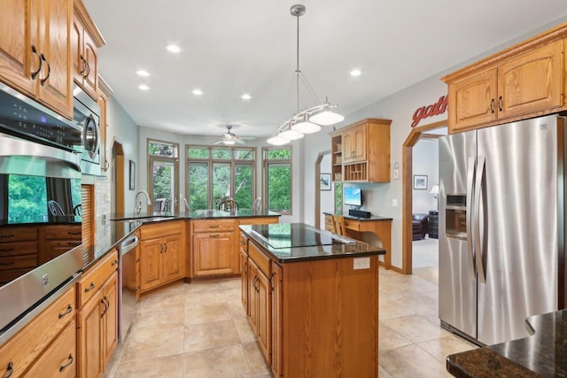 1816 Blue Ridge Trl, Waunakee, WI 53597 - kitchen featuring appliances with stainless steel finishes, a kitchen island, a sink, recessed lighting, and dark stone countertops