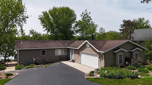 N1423 Silver Canoe Rd, Keshena, WI 54135 - ranch-style house with a garage, driveway, and a shingled roof