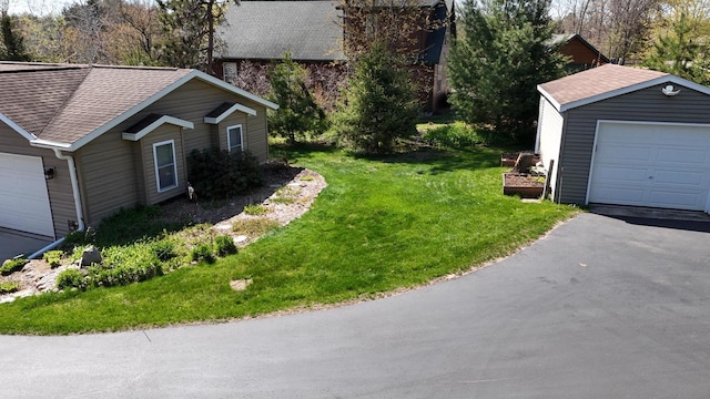 N1423 Silver Canoe Rd, Keshena, WI 54135 - view of property exterior with roof with shingles, a yard, and an outbuilding