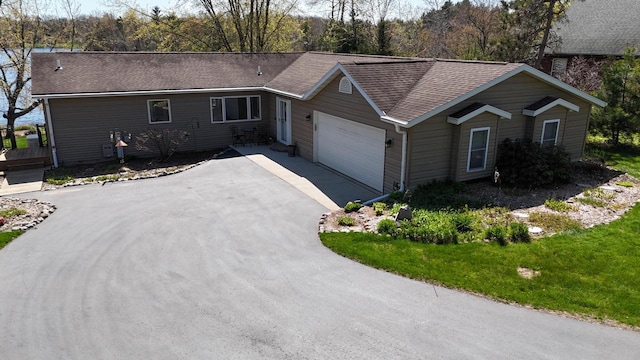 N1423 Silver Canoe Rd, Keshena, WI 54135 - ranch-style home featuring driveway, an attached garage, and roof with shingles
