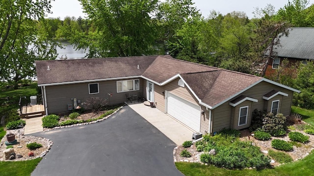 N1423 Silver Canoe Rd, Keshena, WI 54135 - ranch-style home featuring asphalt driveway, an attached garage, and roof with shingles