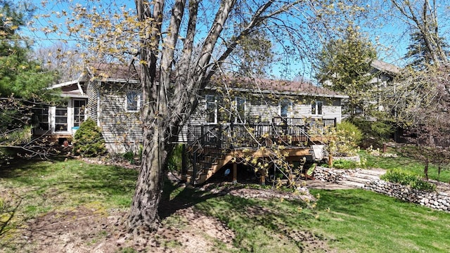 N1423 Silver Canoe Rd, Keshena, WI 54135 - back of property with stairway, a wooden deck, and a yard
