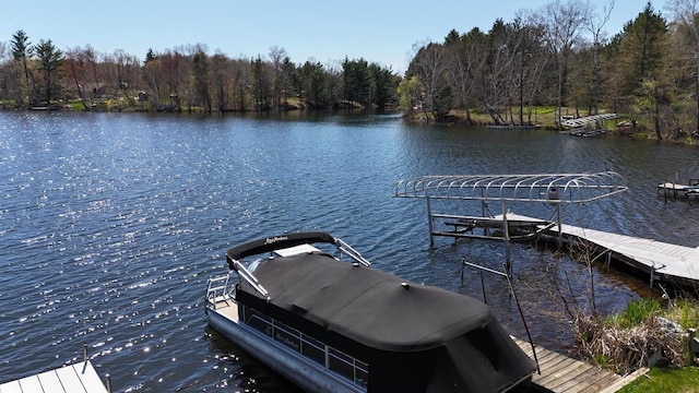 N1423 Silver Canoe Rd, Keshena, WI 54135 - dock featuring a water view, a wooded view, and boat lift