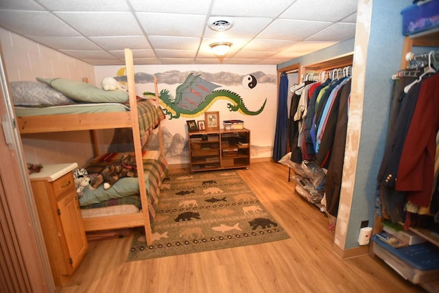 N1423 Silver Canoe Rd, Keshena, WI 54135 - bedroom with light wood-type flooring and a paneled ceiling