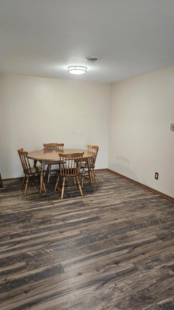 7040 Mariner Dr Unit 103, Mount Pleasant, WI 53406 - dining area with dark wood finished floors and baseboards