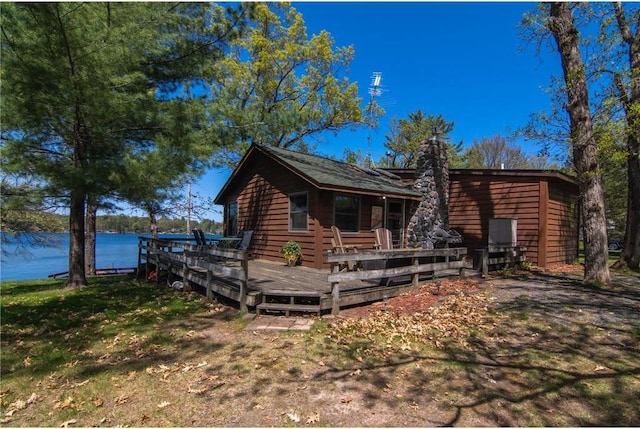 601 Idlewild St Unit 104, Balsam Lake, WI 54810 - view of front of property with a deck with water view and a front yard