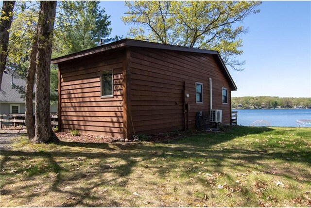 601 Idlewild St Unit 104, Balsam Lake, WI 54810 - view of home's exterior with a yard, a water view, and a cooling unit
