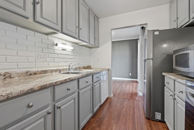 6548 N Bourbon St, Milwaukee, WI 53224 - kitchen with gray cabinets, white dishwasher, dark wood-style flooring, a sink, and backsplash