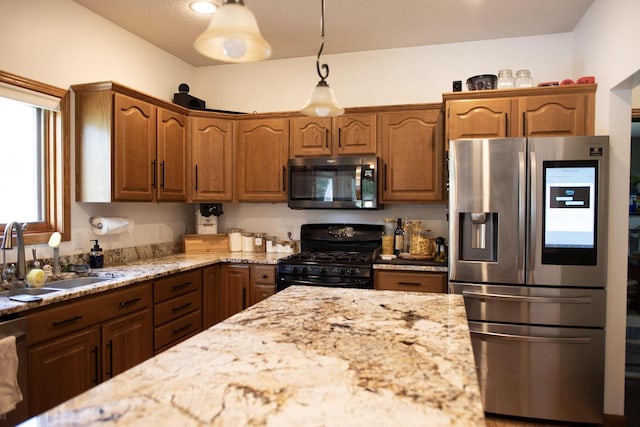 23718 Emblem Ave, Tomah, WI 54660 - kitchen featuring stainless steel appliances, a sink, light stone countertops, hanging light fixtures, and brown cabinetry