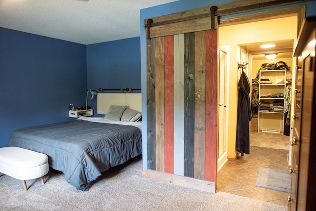 23718 Emblem Ave, Tomah, WI 54660 - carpeted bedroom with a spacious closet, a barn door, and a closet