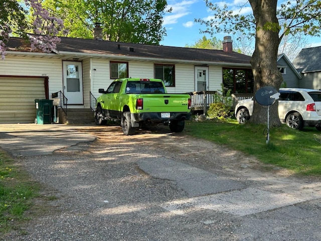916 Fayette Ave, Rib Lake, WI 54470 - ranch-style house featuring a chimney, entry steps, and asphalt driveway