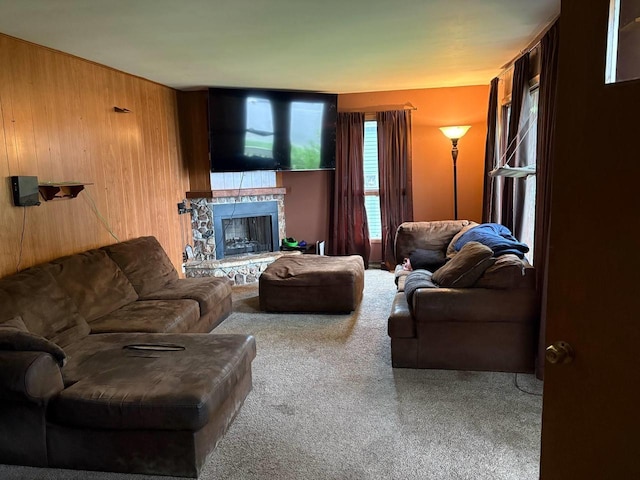 916 Fayette Ave, Rib Lake, WI 54470 - living room with carpet flooring, a stone fireplace, and wood walls