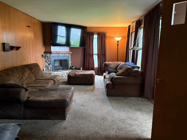 916 Fayette Ave, Rib Lake, WI 54470 - living area featuring carpet flooring, a stone fireplace, and wooden walls