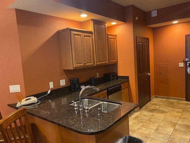2411 River Rd Unit 2443, Wisconsin Dells, WI 53965 - kitchen featuring a sink, stainless steel dishwasher, a peninsula, a textured wall, and dark stone countertops