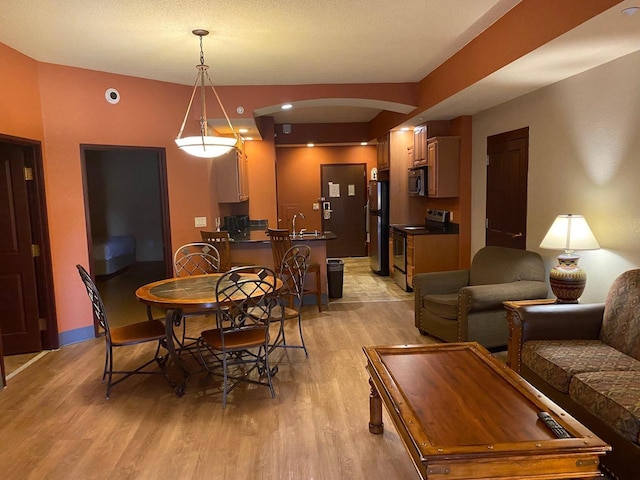 2411 River Rd Unit 2443, Wisconsin Dells, WI 53965 - dining room with arched walkways and light wood-style flooring