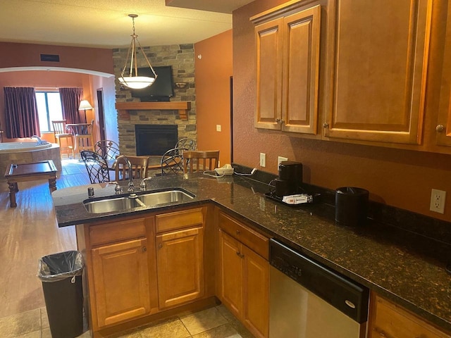 2411 River Rd Unit 2443, Wisconsin Dells, WI 53965 - kitchen with dishwasher, a sink, a peninsula, dark stone counters, and brown cabinets