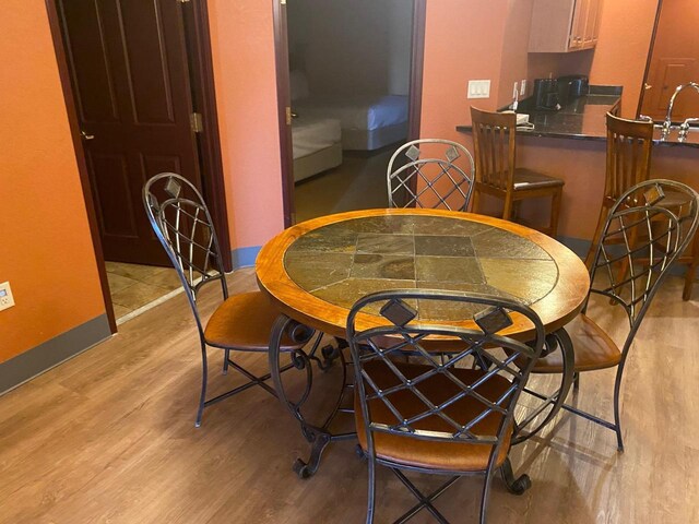 2411 River Rd Unit 2443, Wisconsin Dells, WI 53965 - dining area featuring light wood-type flooring and baseboards