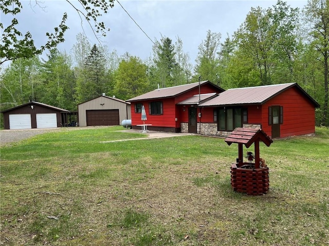 W4670 County Highway F, Springbrook, WI 54875 - view of front of property featuring a detached garage, a front lawn, an outbuilding, and metal roof