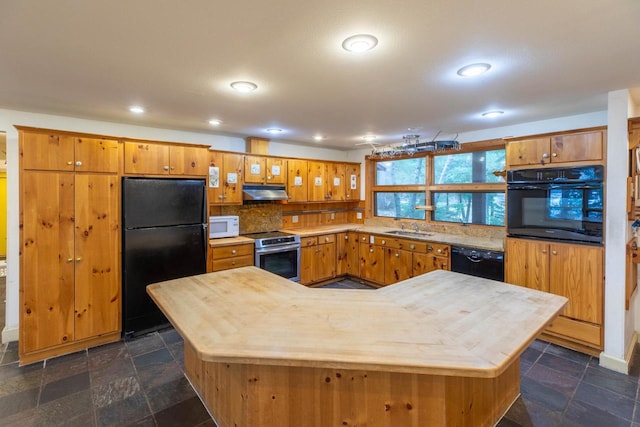 8395 Woolpy Dr, Minocqua, WI 54548 - kitchen with black appliances, under cabinet range hood, a sink, brown cabinets, and tasteful backsplash