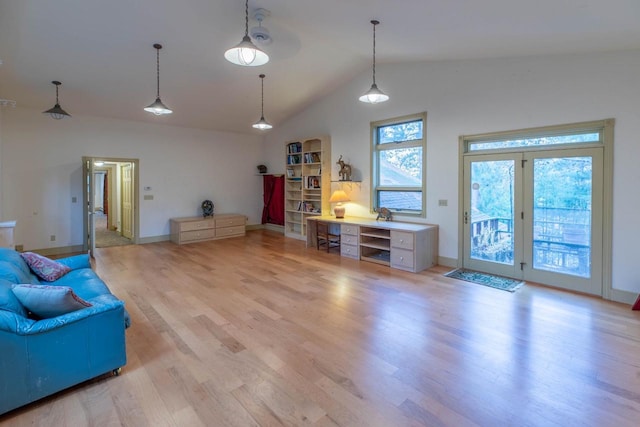 8395 Woolpy Dr, Minocqua, WI 54548 - living area featuring vaulted ceiling, light wood finished floors, and baseboards