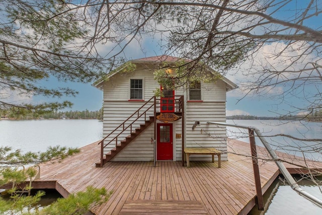 8395 Woolpy Dr, Minocqua, WI 54548 - view of front of property with stairway and a deck with water view