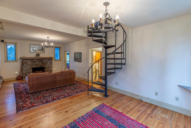 8395 Woolpy Dr, Minocqua, WI 54548 - living area featuring a chandelier, baseboards, stairs, and hardwood / wood-style floors