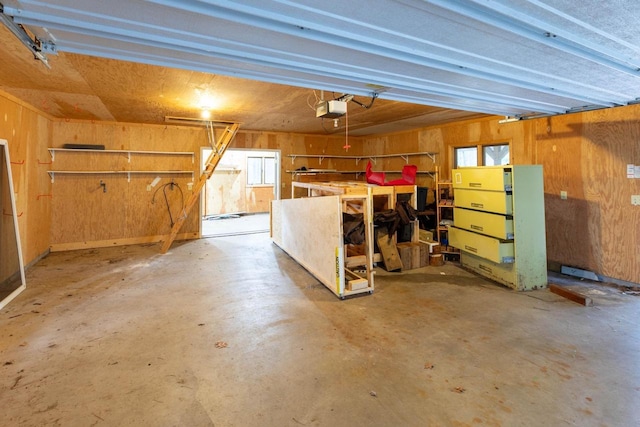 8395 Woolpy Dr, Minocqua, WI 54548 - garage featuring a garage door opener and wooden walls