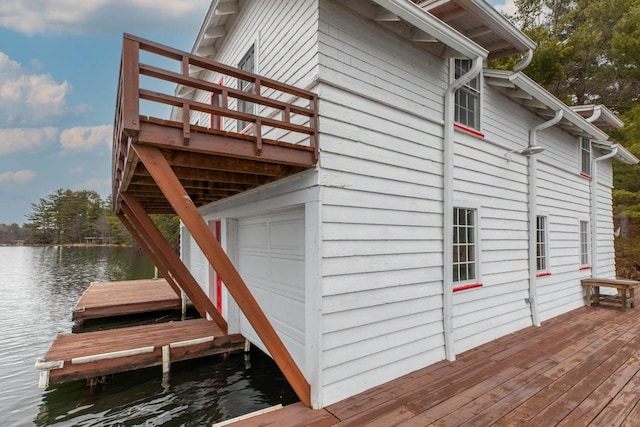 8395 Woolpy Dr, Minocqua, WI 54548 - view of home's exterior featuring a water view, a boat dock, and a garage