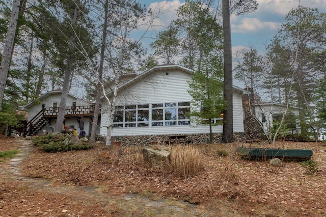 8395 Woolpy Dr, Minocqua, WI 54548 - back of property with stairway and a wooden deck