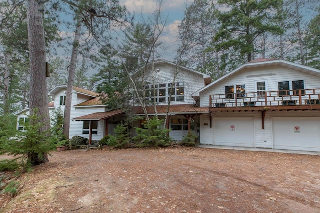 8395 Woolpy Dr, Minocqua, WI 54548 - view of front facade featuring a garage and dirt driveway