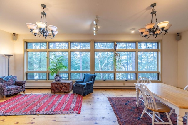 8395 Woolpy Dr, Minocqua, WI 54548 - living room with a chandelier, a baseboard radiator, and hardwood / wood-style flooring