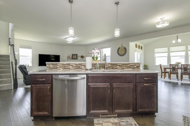W242N5663 Simona Dr, Sussex, WI 53089 - kitchen featuring stainless steel dishwasher, a sink, plenty of natural light, decorative backsplash, and lofted ceiling