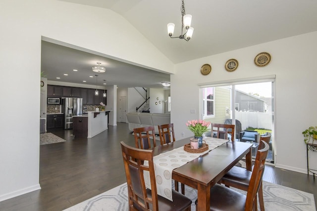 W242N5663 Simona Dr, Sussex, WI 53089 - dining space with lofted ceiling, a chandelier, dark wood-style flooring, stairway, and baseboards