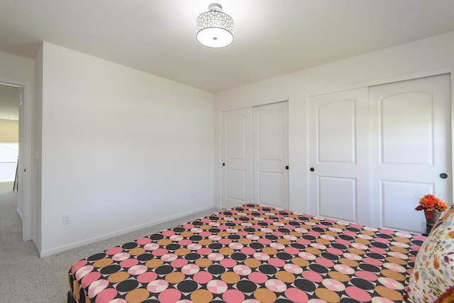 W242N5663 Simona Dr, Sussex, WI 53089 - bedroom featuring carpet flooring, multiple closets, and baseboards