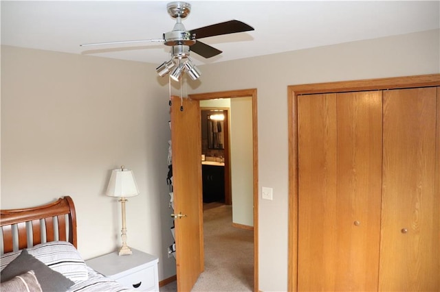 3530 Briarcrest Dr, Eau Claire, WI 54701 - bedroom featuring a closet, light colored carpet, ceiling fan, and baseboards