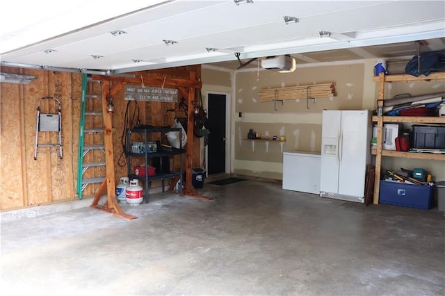 3530 Briarcrest Dr, Eau Claire, WI 54701 - garage with white refrigerator with ice dispenser and a garage door opener