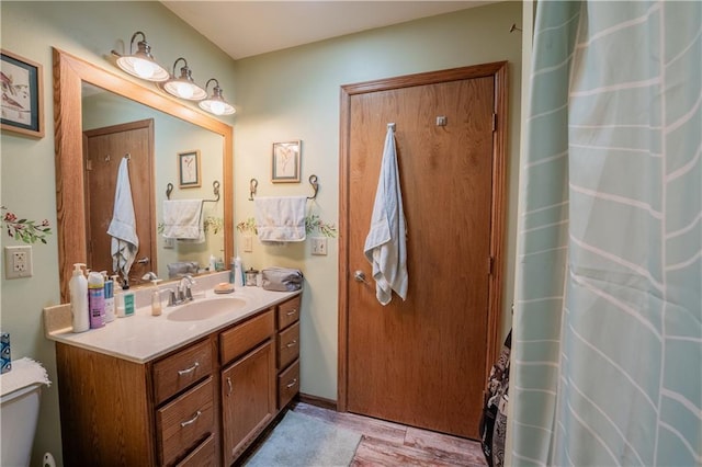 18886 53rd Ave, Chippewa Falls, WI 54729 - full bathroom featuring wood finished floors, vanity, toilet, and curtained shower