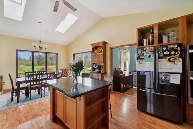 N124W13900 Lovers Ln, Germantown, WI 53022 - kitchen with open shelves, freestanding refrigerator, a skylight, a chandelier, and light wood-type flooring