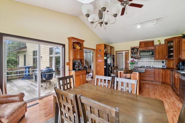 N124W13900 Lovers Ln, Germantown, WI 53022 - dining space featuring a chandelier, light wood-style flooring, vaulted ceiling, rail lighting, and ceiling fan
