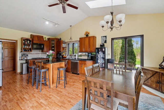 N124W13900 Lovers Ln, Germantown, WI 53022 - dining area with a skylight, a chandelier, ceiling fan, light wood finished floors, and high vaulted ceiling
