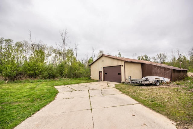 N124W13900 Lovers Ln, Germantown, WI 53022 - view of property exterior featuring a garage, an outbuilding, and a yard