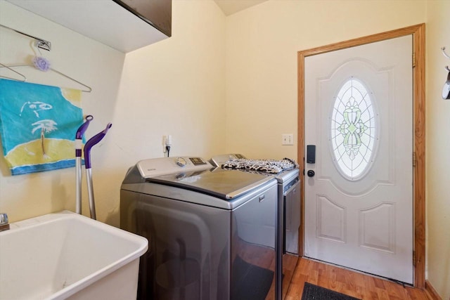 N124W13900 Lovers Ln, Germantown, WI 53022 - laundry area featuring washing machine and clothes dryer and light wood-type flooring