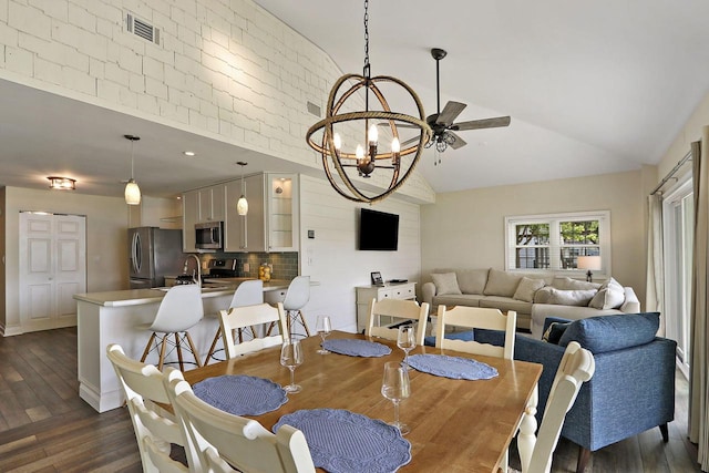 W5229 Surfwood Dr Unit 3B, Elkhorn, WI 53121 - dining space featuring dark wood-style floors, a chandelier, a ceiling fan, and high vaulted ceiling