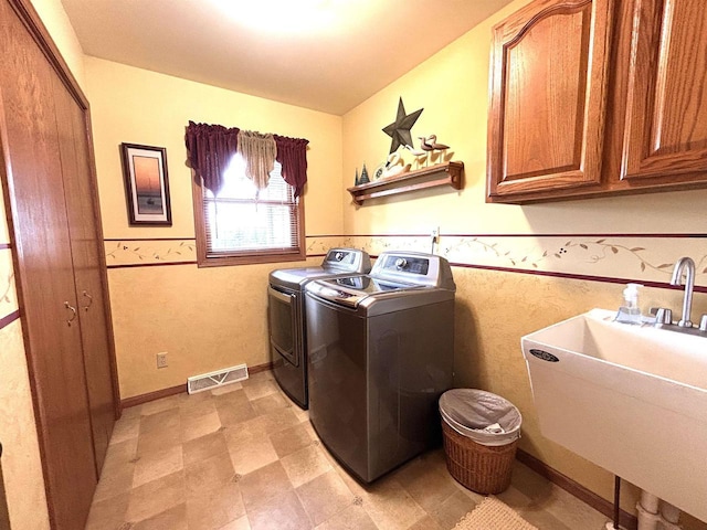 12541 Fleetwood Rd, Tomah, WI 54660 - laundry room with cabinet space, washer and dryer, and wainscoting