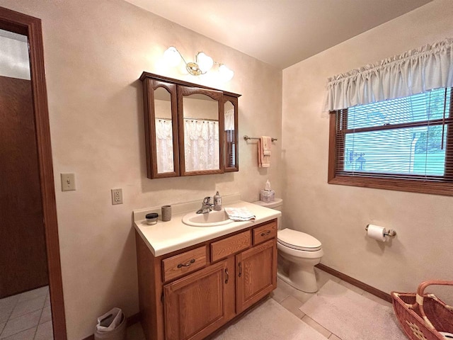 12541 Fleetwood Rd, Tomah, WI 54660 - bathroom with tile patterned floors, toilet, vanity, and baseboards