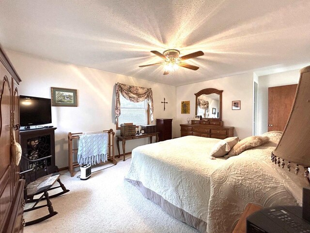 12541 Fleetwood Rd, Tomah, WI 54660 - bedroom featuring light carpet, a ceiling fan, and a textured ceiling