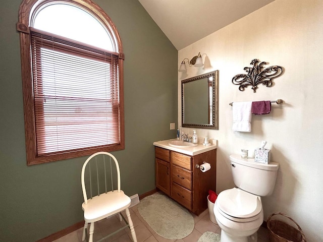 12541 Fleetwood Rd, Tomah, WI 54660 - half bath featuring lofted ceiling, tile patterned flooring, vanity, toilet, and baseboards