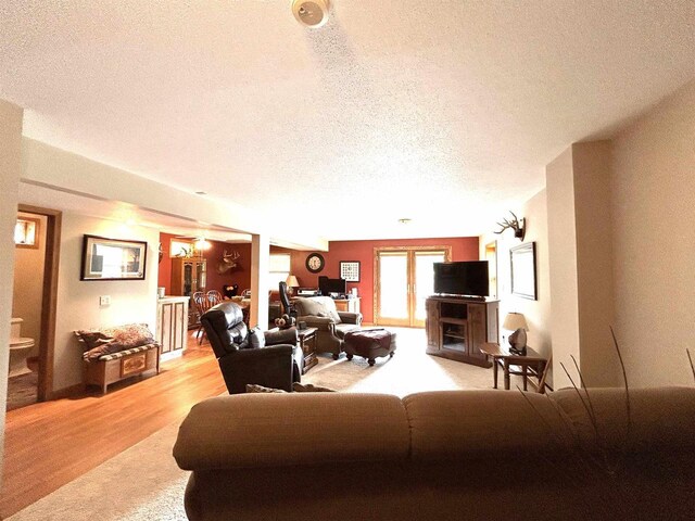12541 Fleetwood Rd, Tomah, WI 54660 - living area with a textured ceiling and light wood-style floors